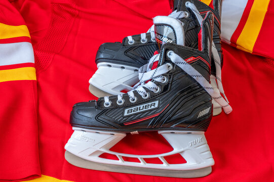 Calgary, Alberta - December 22, 2022: C Calgary Flames NHL team baseball cap and jersey with Bauer skates.