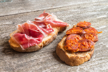 bread toast with chorizo and ham (spanish tapa)