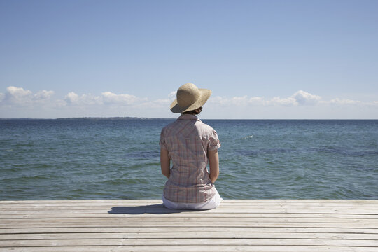 Woman Sitting at End of Dock