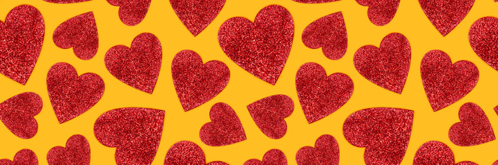 Fototapeta premium Banner with pattern made of red glittering hearts. Creative festive background.