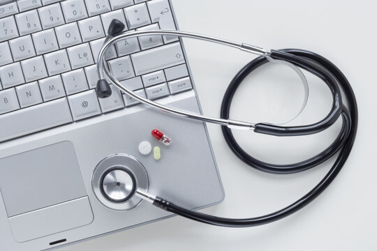 Laptop Computer with Stethoscope and Pills