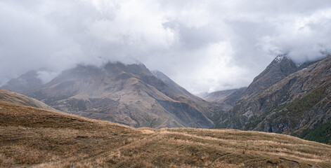 Fototapeta premium Autumn landscape in the mountains on hike from the hamlet of Les Cours to Lac du Pontet and back, near Villar d'Arene and Col du Lautaret, Hautes-Alpes, France