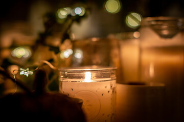Fototapeta na wymiar Candles and fairy lights, with a shallow depth of field