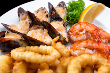 Seafood, mussels, shrimp and squid in batter, with lemon