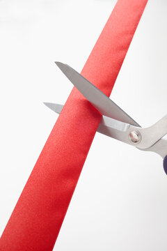 Scissors Cutting Red Ribbon