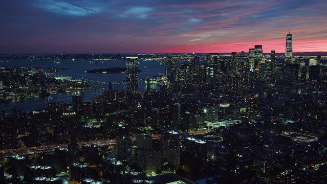 
Beautiful Aerial Shot of Lower Manhattan, Wall Street at Dusk. Traffic in Several Streets and Avenues. Famous Skyscrapers and Piers. East River. High Quality Footage Helicopter Flight.