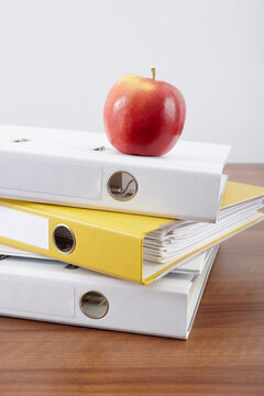 Stack of Binders and Apple