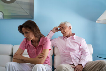 Couple on Couch with Woman's Back Toward Man