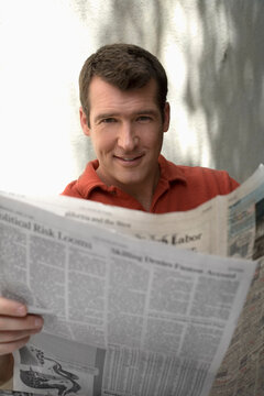 Man Reading Newspaper Outdoors