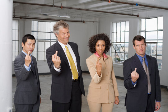 Group Portrait of Business People Making Rude Hand Gesture