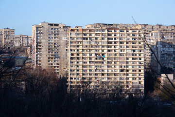View of a panel house with windows in Georgia. Old typical socialist residential soviet house. Poor...