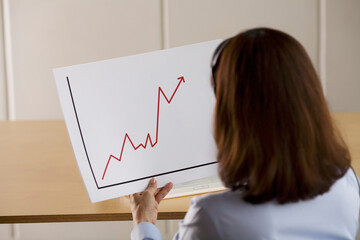 Woman Holding a Line Graph