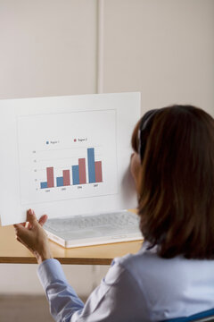 Woman Holding a Bar Graph