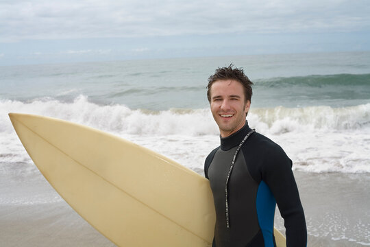 Man Holding Surfboard