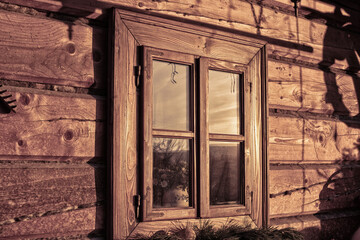 Window of a log house in early morning.Winter season.