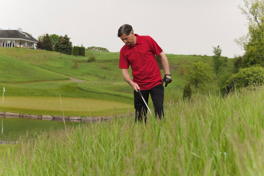 Man Looking for Lost Golf Ball on Golf Course