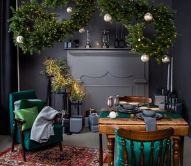 beautiful dark christmas interior with fake fireplace and armchair