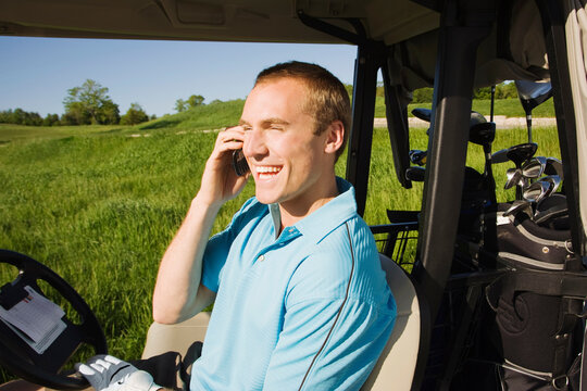 Man Riding Golf Cart