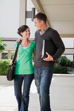 University Students on Campus Holding Books