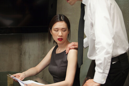 Businessman with Hand on Businesswoman's Shoulder