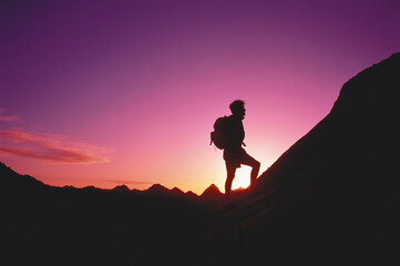 Silhouette of Man Hiking Below The White Cliffs at Sunset Zion National Park, Utah, USA
