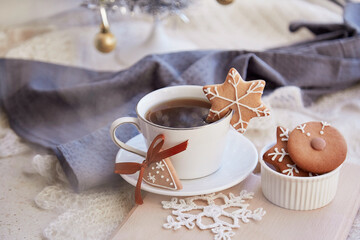 Cup of coffee with cute ginger Christmas cookies. Aesthetic winter breakfast. Cozy warm home background. Christmas food