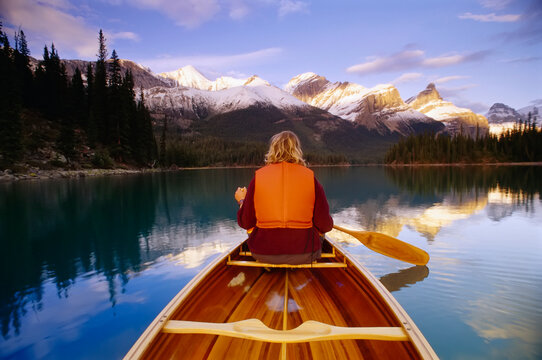 Woman in Canoe on Lake, Maligne Lake, Jasper National Park, Alberta, Canada