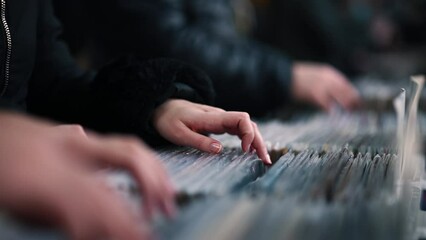 Close-up on man hands browsing vinyl album in a record store - Powered by Adobe