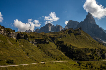 Sunny day on Rolle mountain pass in Dolomites