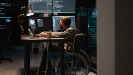 App developer with physical disability working on IT software coding, using source code and big...