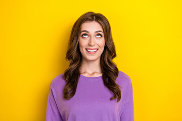Fototapeta premium Photo of young funny excited lady wear violet pullover smile positive looking up curious empty space new brand isolated on yellow color background