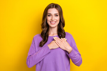 Photo of shiny charming lady wear violet sweater arms chest heart smiling isolated yellow color...