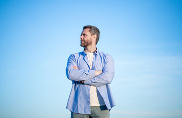 pensive caucasian man standing peaceful. pensive man in shirt outdoor. pensive man on sky background