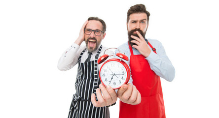 Failed deadline. Man bearded hipster and mature chef apron white background. Working hours and lunch break. Lack of time. Check what time is it. It is lunch time. Men cooks with alarm clock