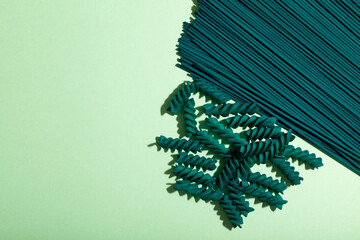 Spaghetti and Fusilli pasta with chlorella and spirulina extract, close-up. Pasta products with...