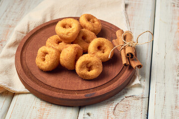 Cinnamon sugar mini donuts on a wooden table