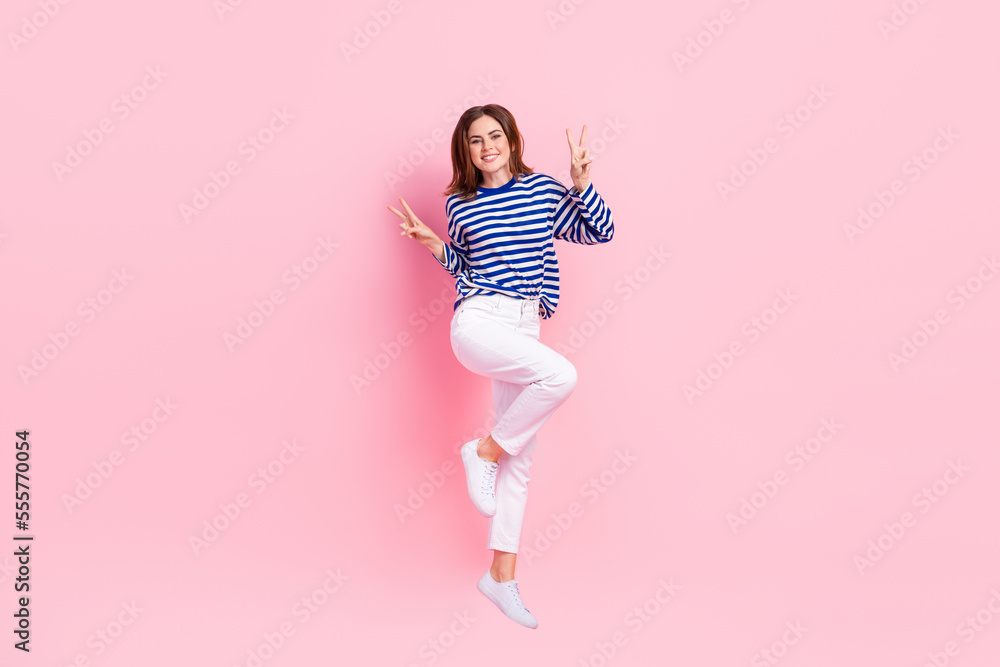 Sticker Full size photo of charming overjoyed girl jumping hands fingers show v-sign isolated on pink color background