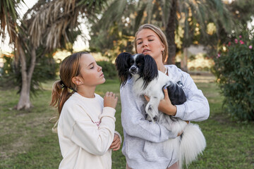 Girls playing with a dog in the park