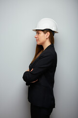 Profile portrait of woman engineer in white safety helmet. Isolated portrait. - 555770263