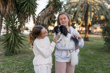 Girls playing with a dog in the park