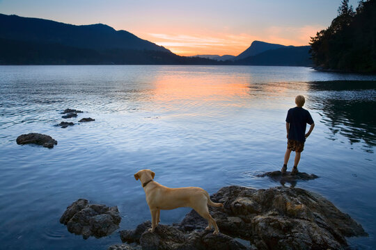Teenager and Dog looking at Sunset, Fulford Harbour, Salt Spring Island, British Columbia, Canada