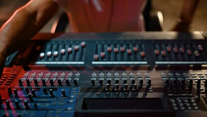 Sound producer hands are using a music mixer with editing tools