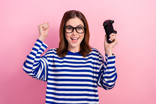 Photo of overjoyed cute lady have fun rejoice win competition finish level hooray yeah isolated on pink color background