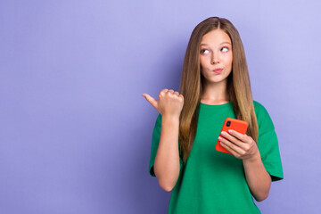 Fototapeta premium Photo of cute minded lady hand index empty space look offer proposition hmm dilemma want buy new device isolated on purple color background