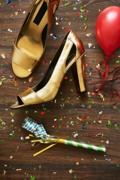 Close-up of Shoes, Noisemaker, Balloon and Confetti