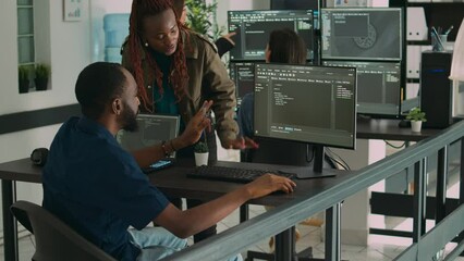 African american team of developers talking about source code running on screen, analyzing server information. Database admins collaborating on data coding project in ai programming room. - Powered by Adobe