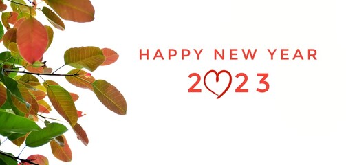 'HAPPY NEW YEAR 2023' in green and pink colors with colorful branches and leaves background, concept for greeting invitation card and happy new year 2023 concept.