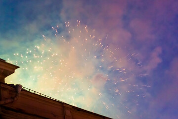 Fireworks in the evening sky under the city