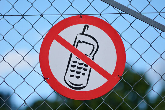 Close-up of, No Cellphone Sign on Fence