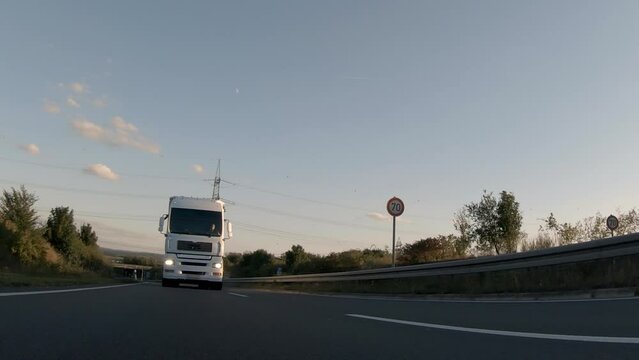 Semi trucks van cargo and parcel delivery driving on a highway. White Van delivers goods in early hours of the Morning 